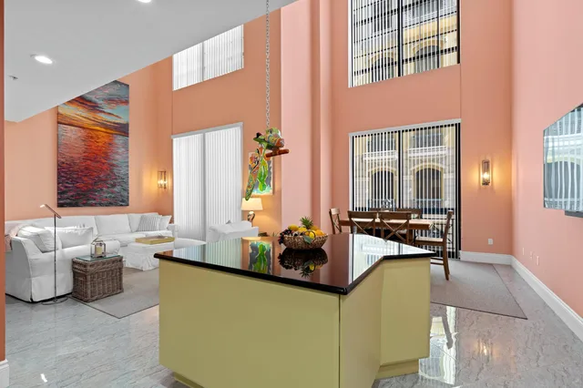 a kitchen with stainless steel appliances kitchen island granite countertop a stove a sink and a refrigerator