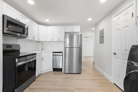 a kitchen with stainless steel appliances a refrigerator stove and microwave