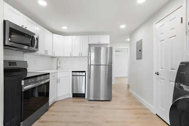 a kitchen with stainless steel appliances a refrigerator stove and microwave