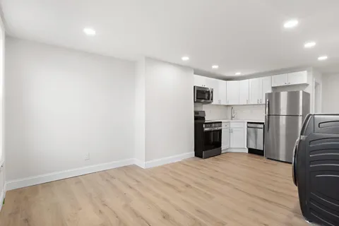 a kitchen with a refrigerator and a stove top oven