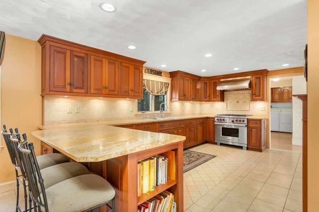 a kitchen with stainless steel appliances granite countertop a sink counter space and a stove