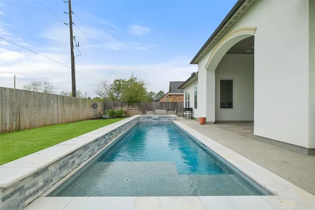 a view of a swimming pool with a back yard