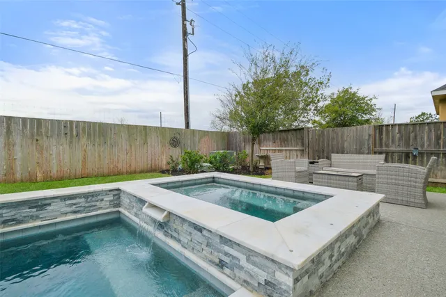 a view of a backyard with a tub and fire pit