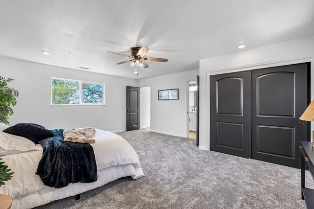 a bedroom with a bed and a chandelier