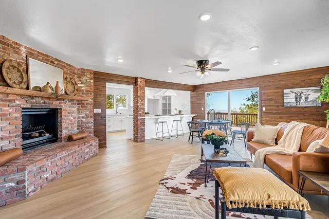 a living room with furniture a fireplace and a flat screen tv