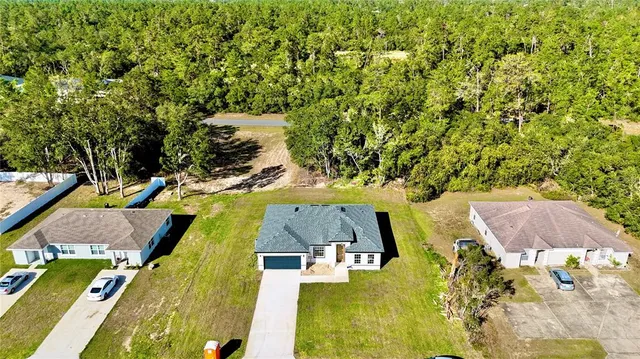 an aerial view of residential houses with swimming pool