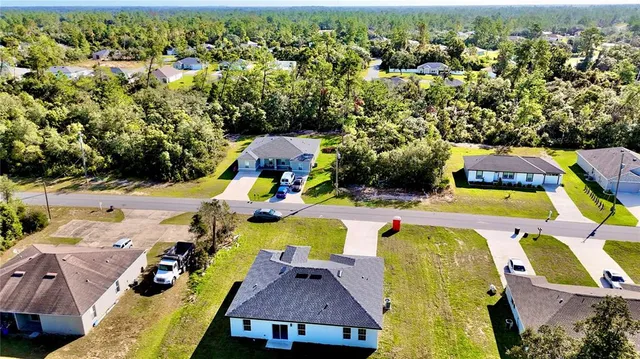 an aerial view of a house with a swimming pool