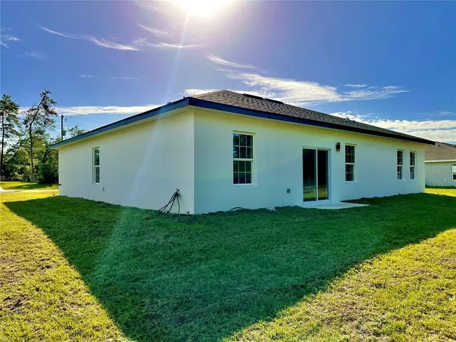 a backyard of a house with plants and entertaining space