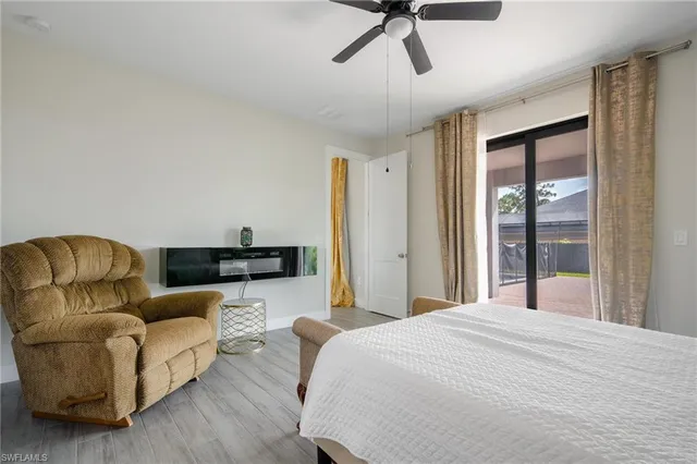 a spacious bedroom with a bed couch and window