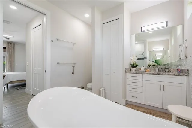 a spacious bathroom with a sink and a mirror