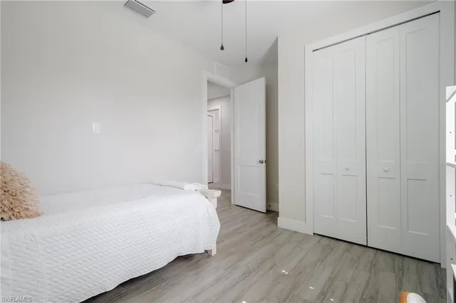 a room with a bed and wooden floor