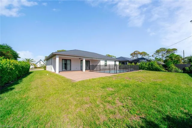 a front view of a house with yard and green space