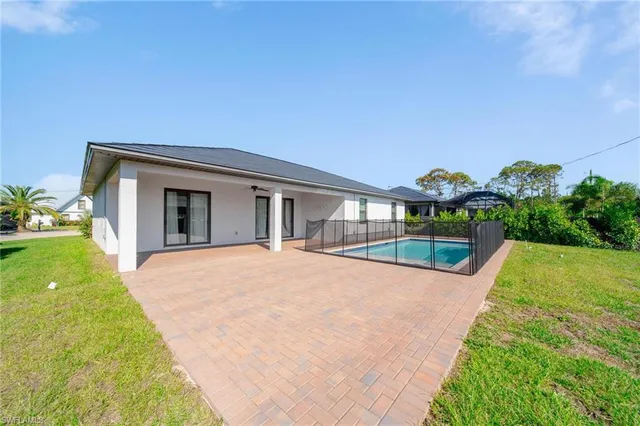a view of an house with swimming pool and porch