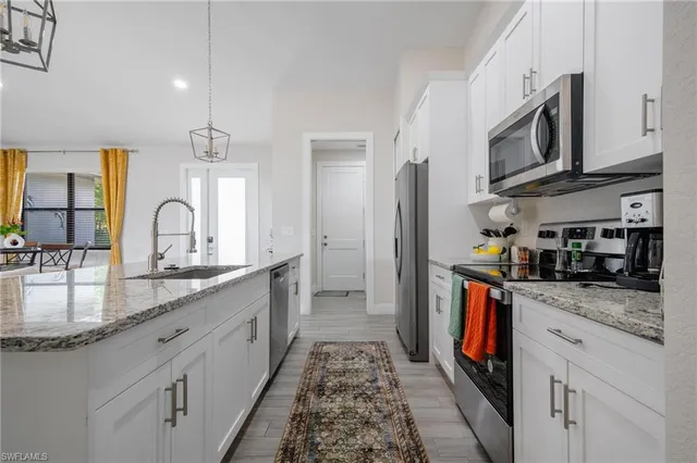 a kitchen with stainless steel appliances granite countertop a sink and stove