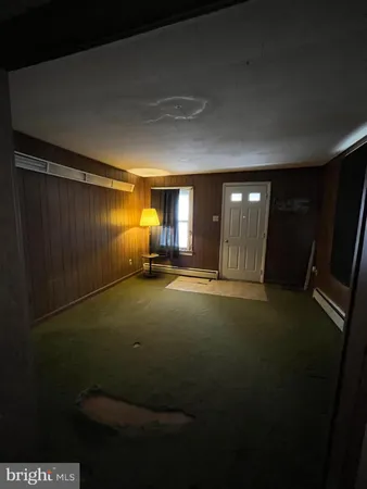 a view of empty room with window and fireplace