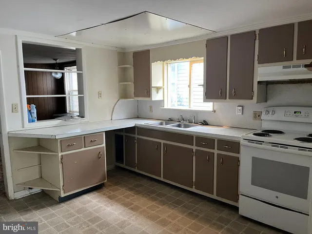 a kitchen with stainless steel appliances a refrigerator and a stove top oven