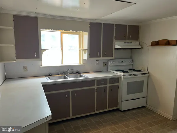 a view of a kitchen with a sink dishwasher and a refrigerator
