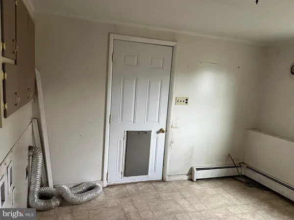 a view of empty room with window and fireplace