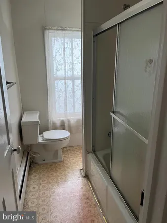an empty room with a empty space and windows