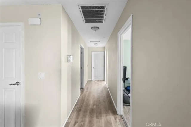a view of a hallway with wooden floor