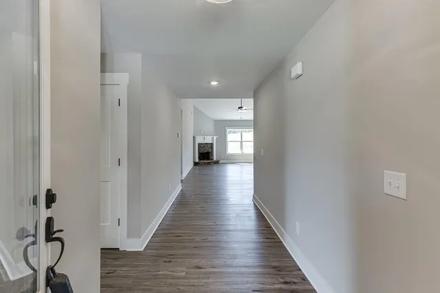 a view of a hallway with wooden floor