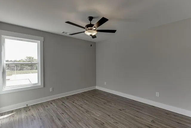 wooden floor in an empty room with a window