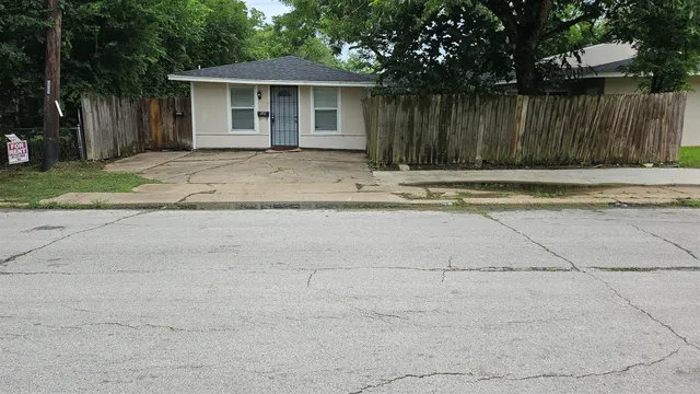 a front view of a house with a fence
