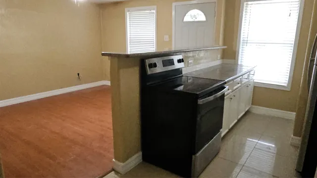 a kitchen with granite countertop cabinets and window