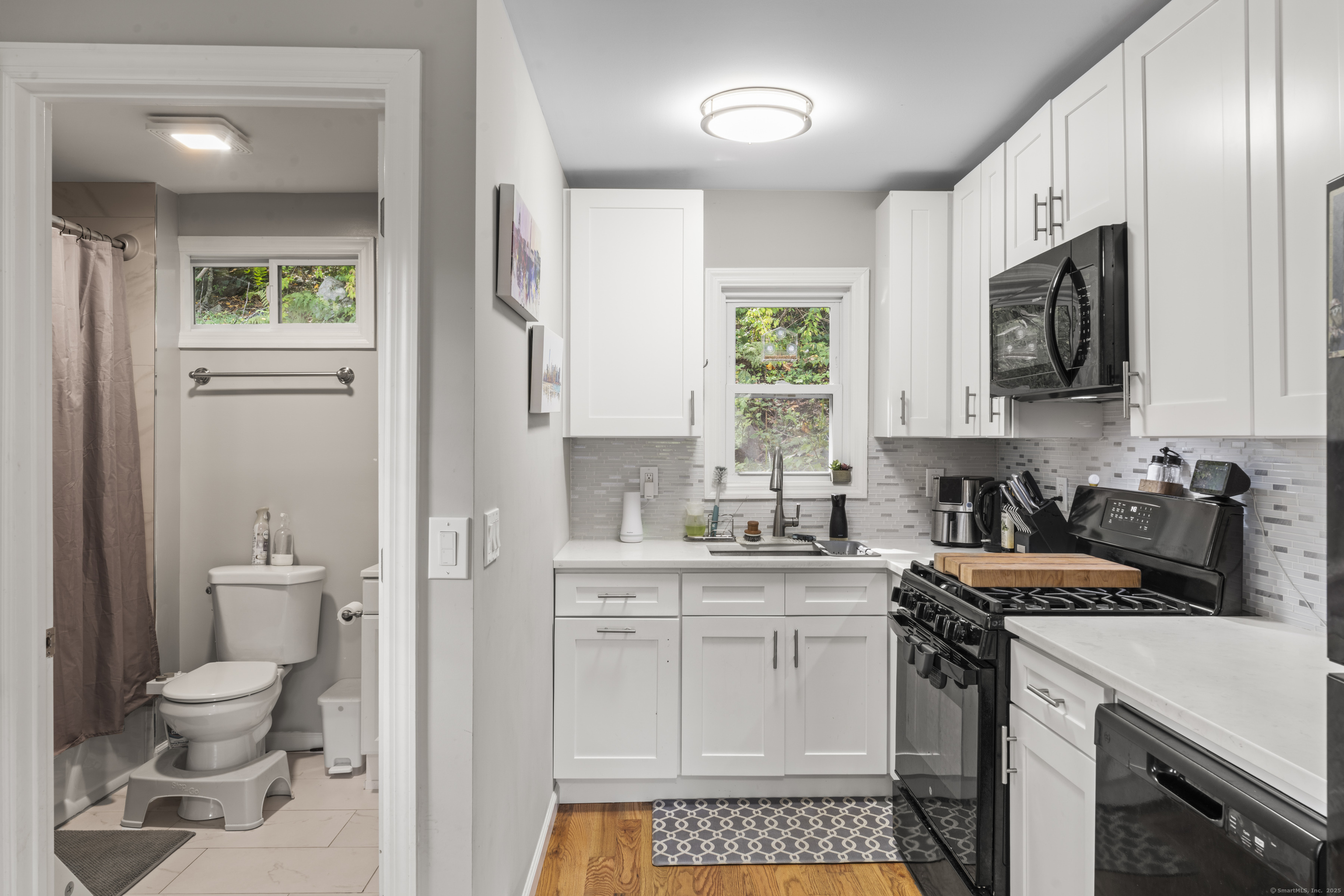 199 Riverside Road Newtown, CT 06482 - Photo 11 of 28 a kitchen with a sink a stove and cabinets