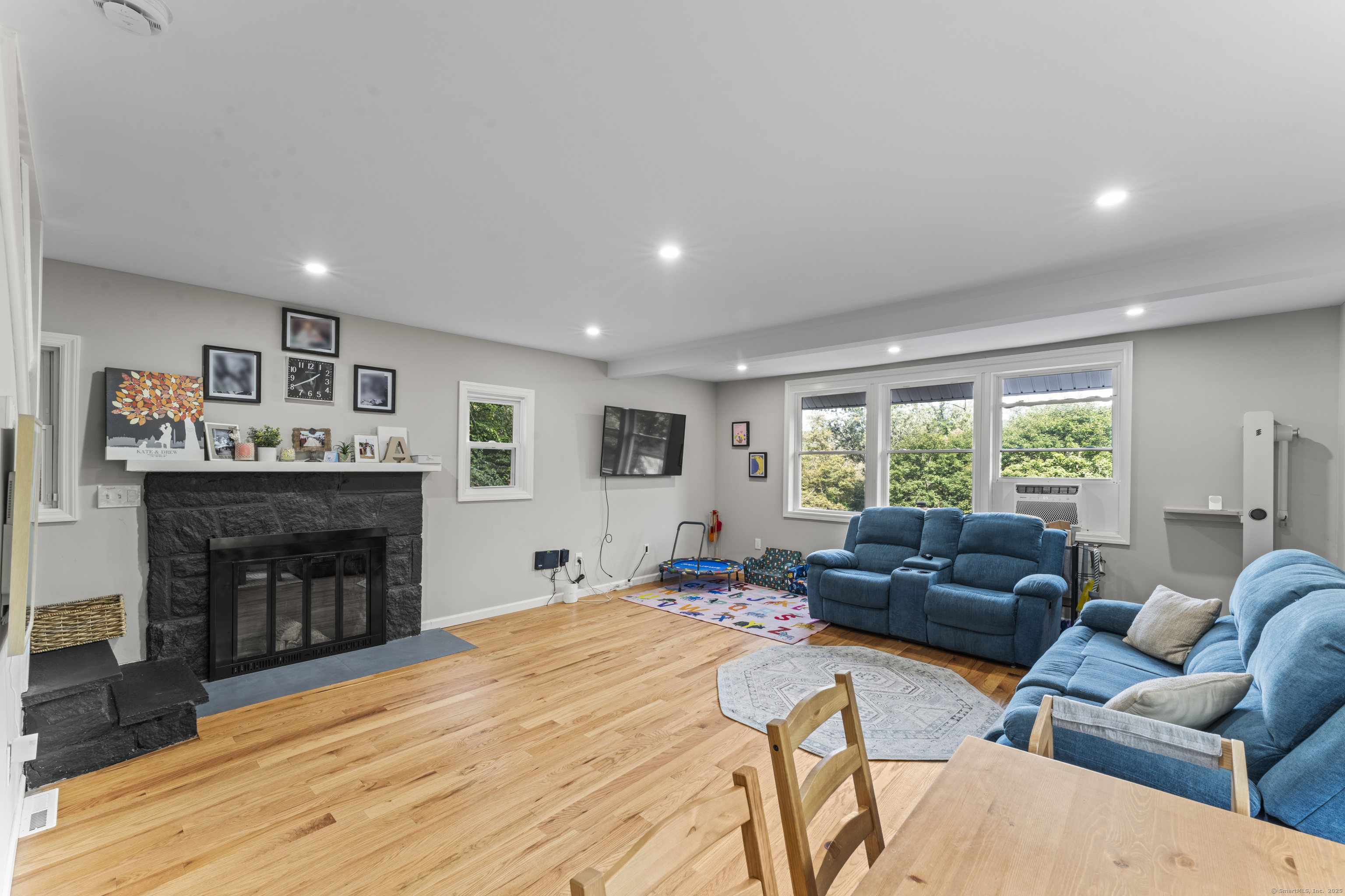 199 Riverside Road Newtown, CT 06482 - Photo 4 of 28 a bedroom with furniture and a fireplace