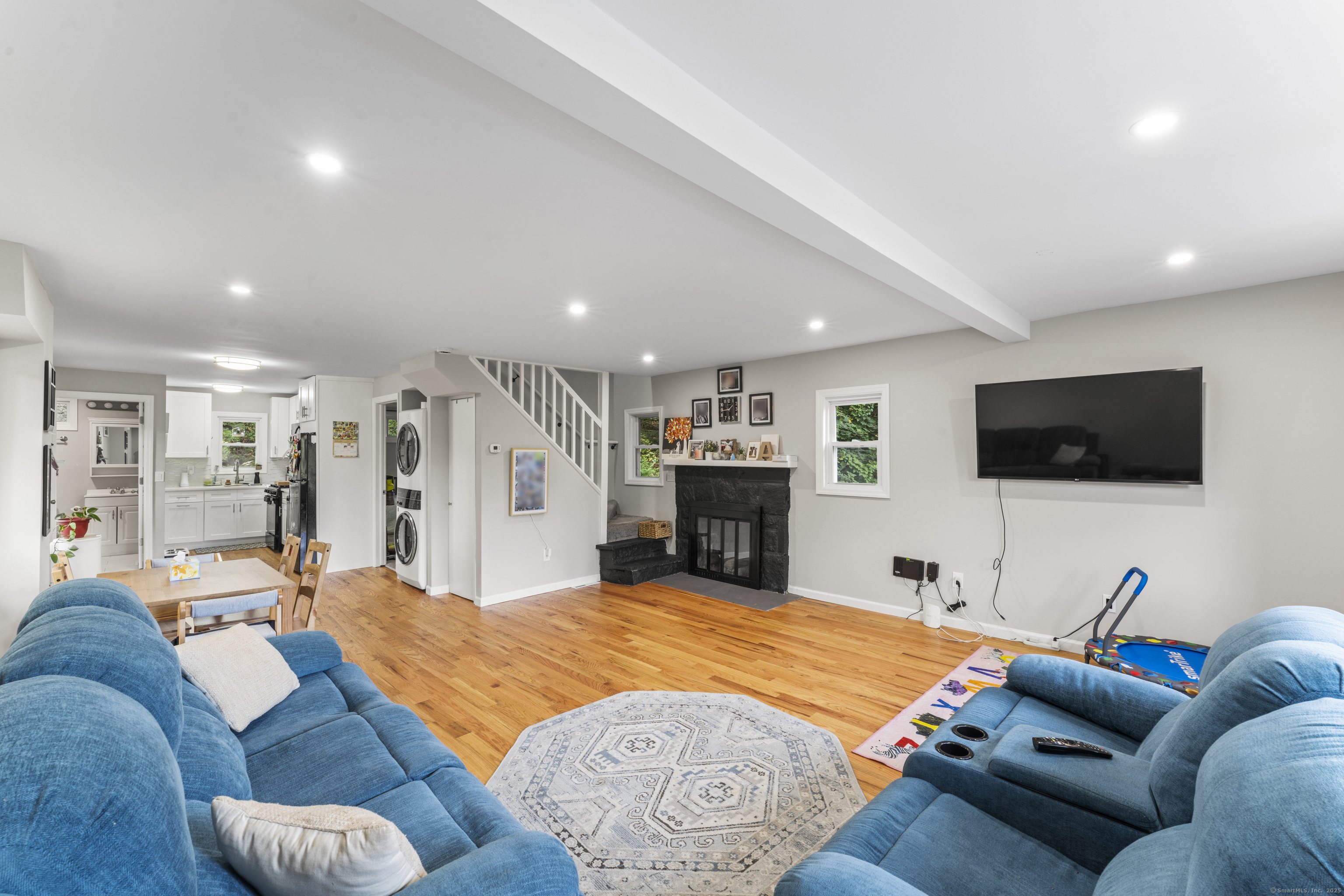 199 Riverside Road Newtown, CT 06482 - Photo 7 of 28 a living room with furniture and a flat screen tv