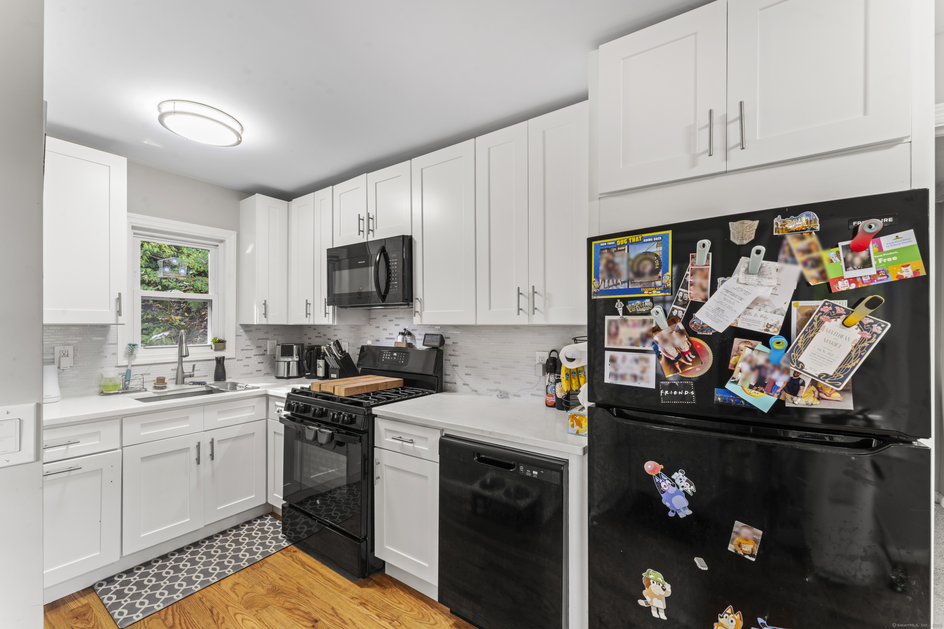 199 Riverside Road Newtown, CT 06482 - Photo 9 of 28 a kitchen with stainless steel appliances cabinets and a window