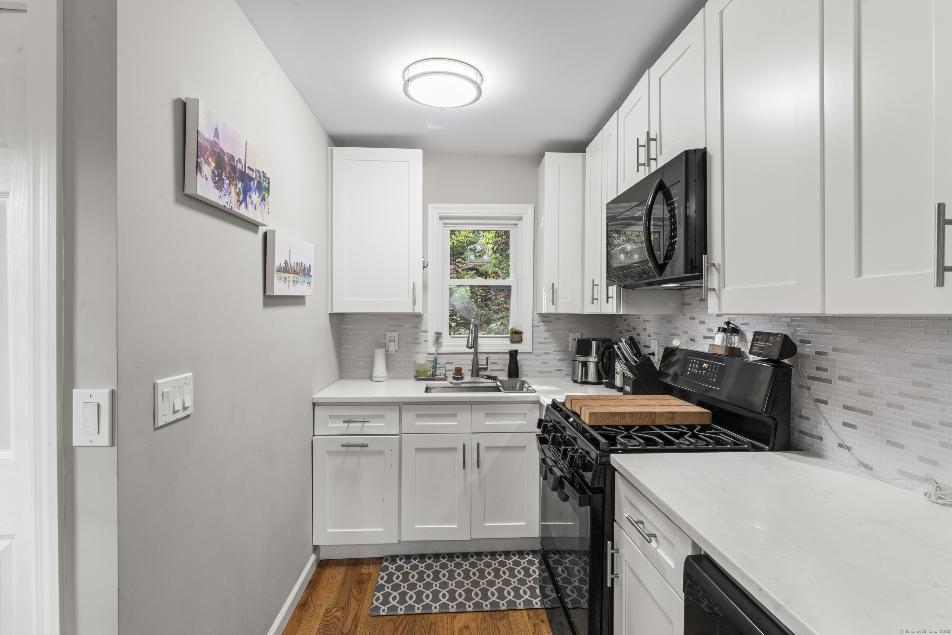 199 Riverside Road Newtown, CT 06482 - Photo 10 of 28 a kitchen with a sink a stove and cabinets