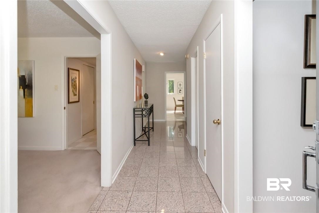 305 Fern Hill Court Mobile, AL 36608 - Photo 12 of 53 Corridor with a textured ceiling and light colored carpet
