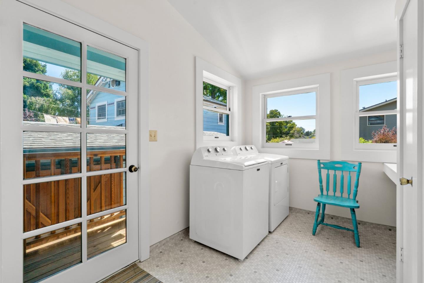505 Cayuga Street Santa Cruz, CA 95062 - Photo 53 of 57 a room with a chair and white cabinets next to a window