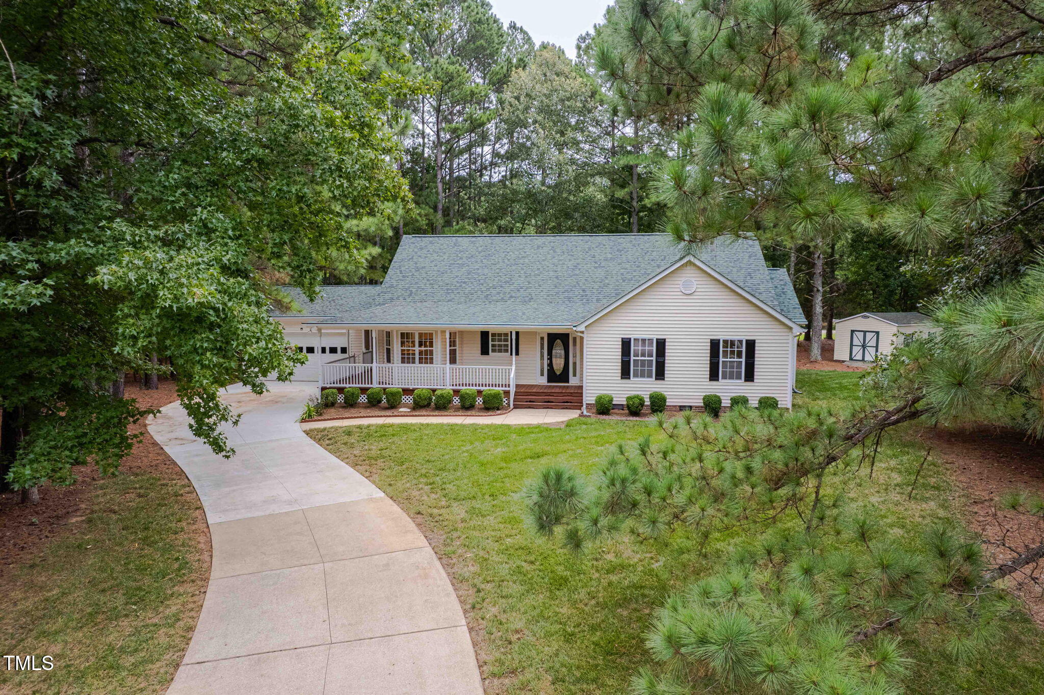 a aerial view of a house with yard and green space