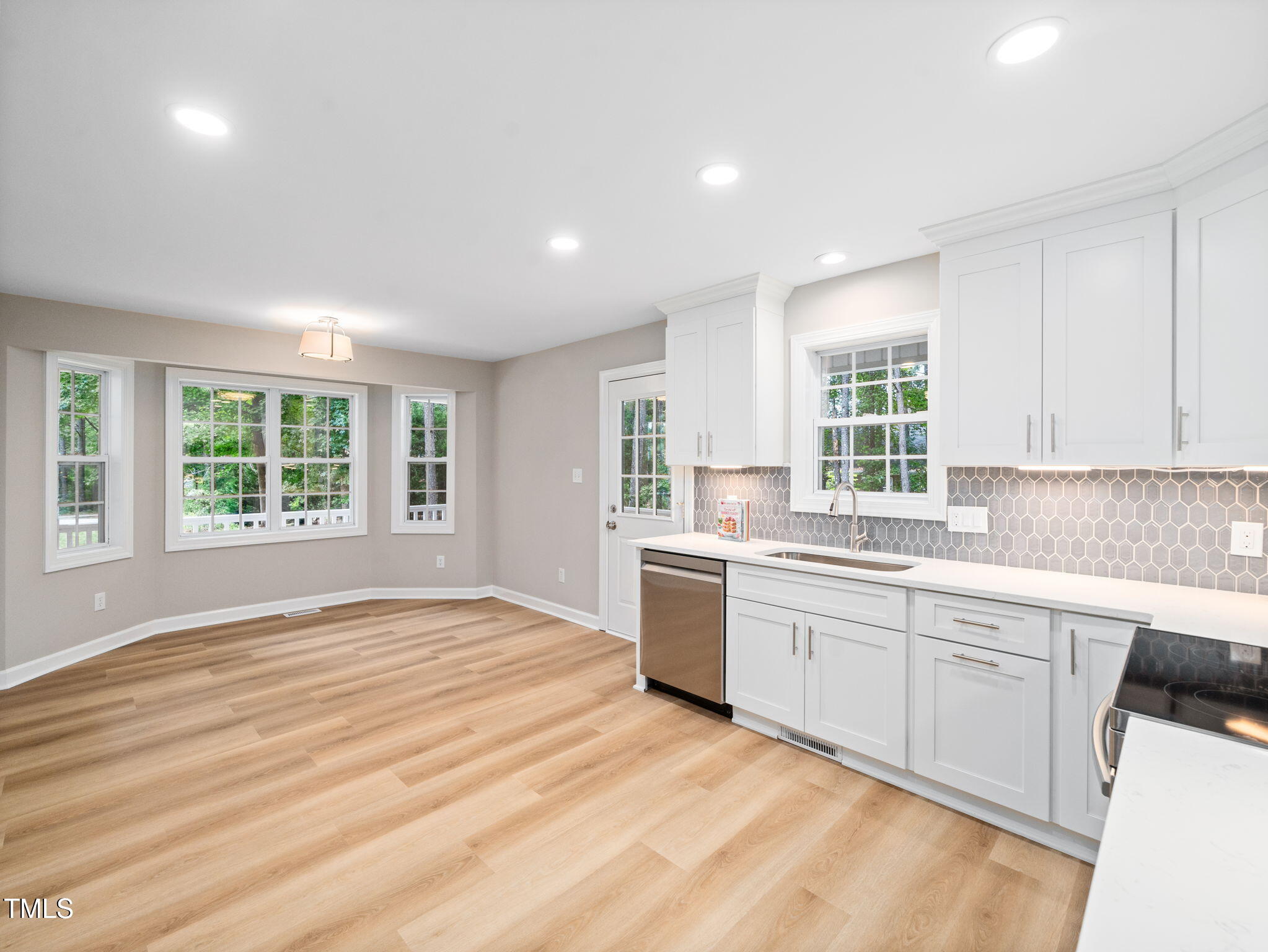 4700 Carolton Drive Raleigh, NC 27606 - Photo 10 of 29 a large kitchen with kitchen island a sink wooden floor and appliances