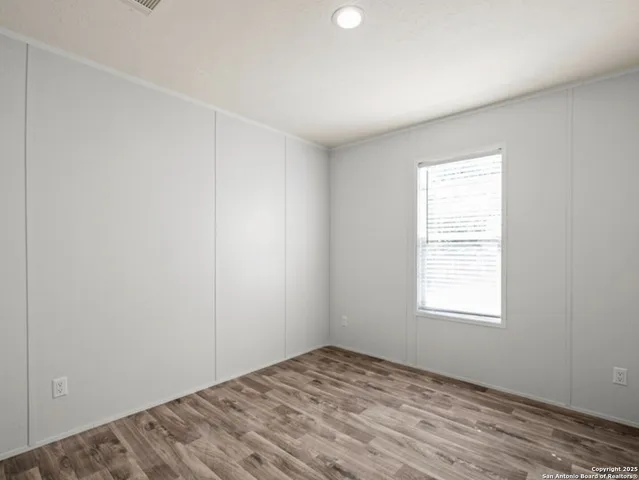 a view of a room with wooden floor and closet