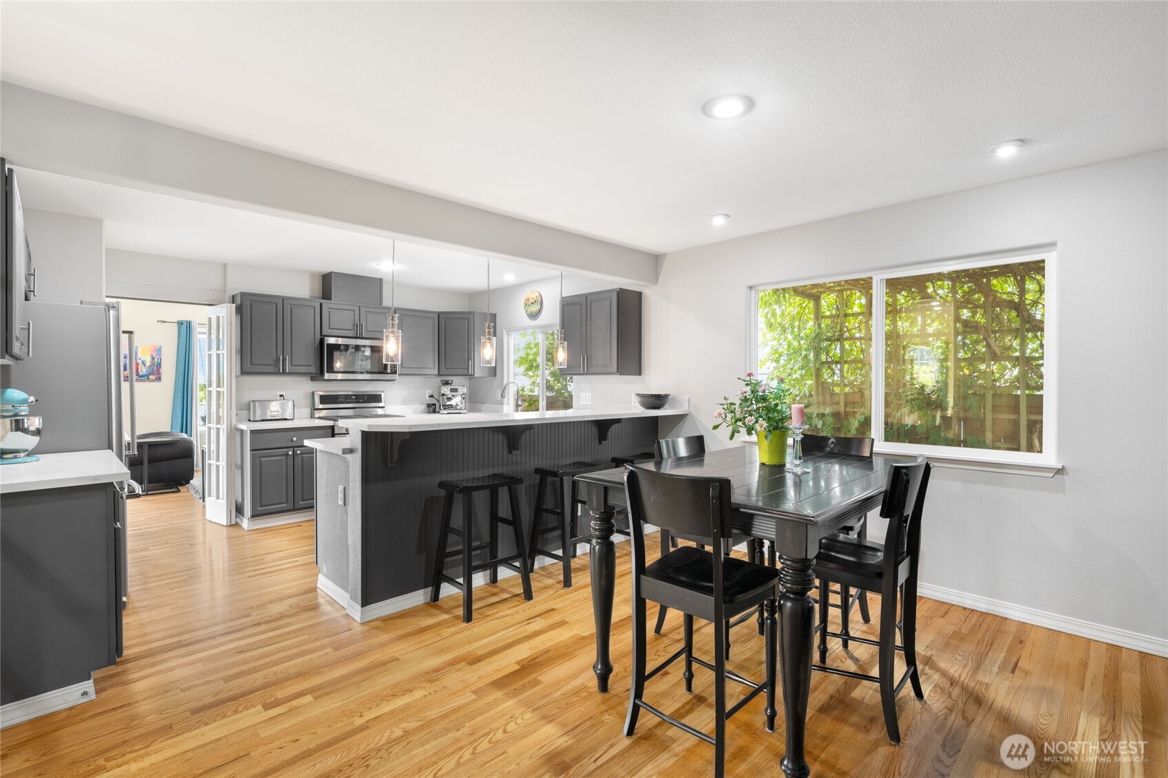 16267 16th Avenue Southwest Burien, WA 98166 - Photo 13 of 40 a view of a dining room with furniture and wooden floor