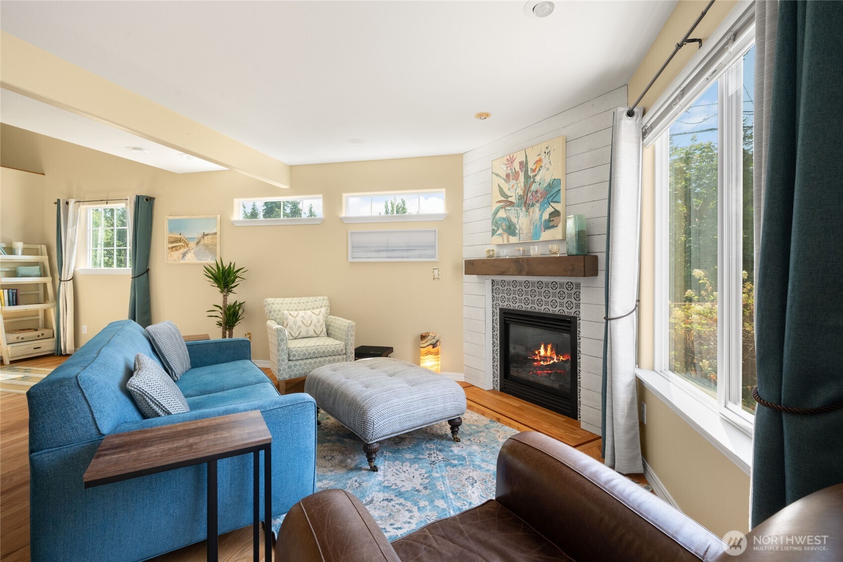 16267 16th Avenue Southwest Burien, WA 98166 - Photo 5 of 40 a living room with furniture a fireplace and a large window