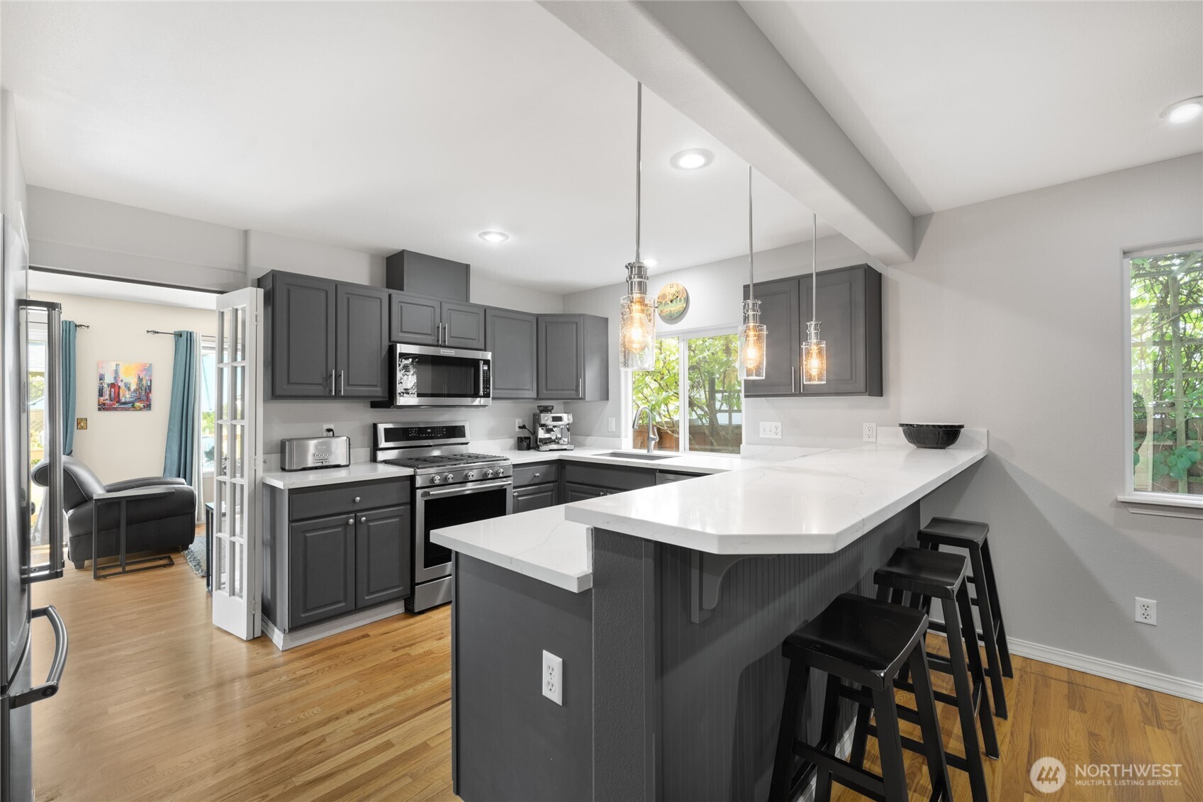 16267 16th Avenue Southwest Burien, WA 98166 - Photo 10 of 40 a kitchen with kitchen island a stove a sink and a refrigerator