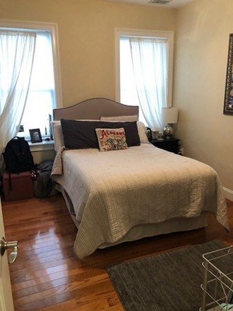 61 Wait Street, Unit 3 Boston, MA 02120 - Photo 3 of 11 a bedroom with a bed and a window