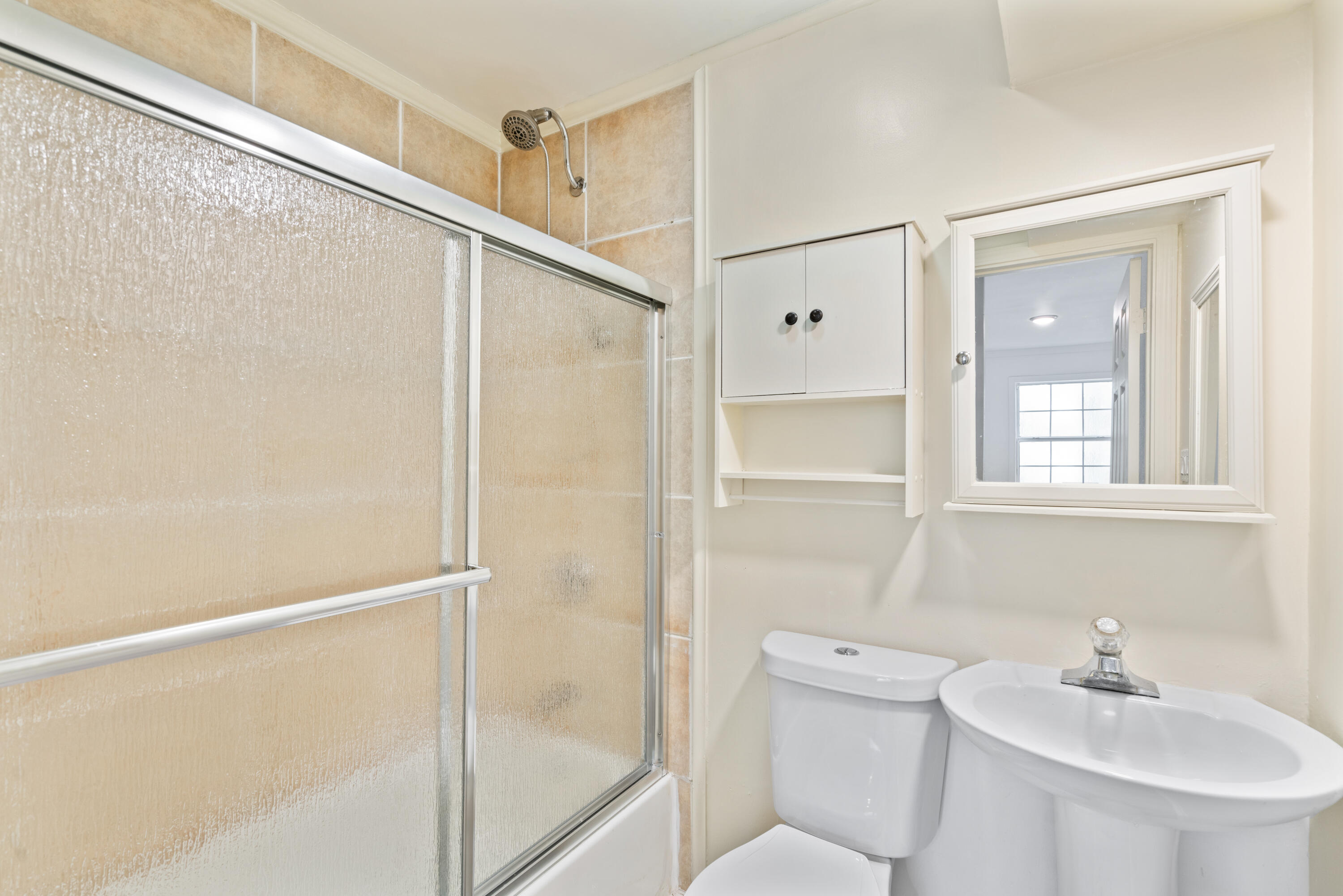 200 East Harborview Road Santa Rosa Beach, FL 32459 - Photo 13 of 20 a bathroom with a sink a mirror and a shower