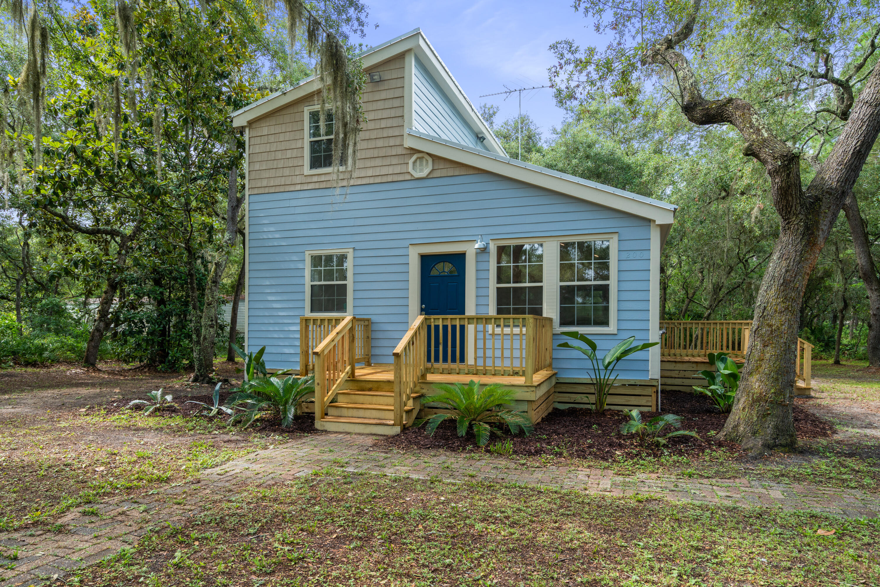 200 East Harborview Road Santa Rosa Beach, FL 32459 - Photo 2 of 20 a view of a house with a yard chairs and a patio
