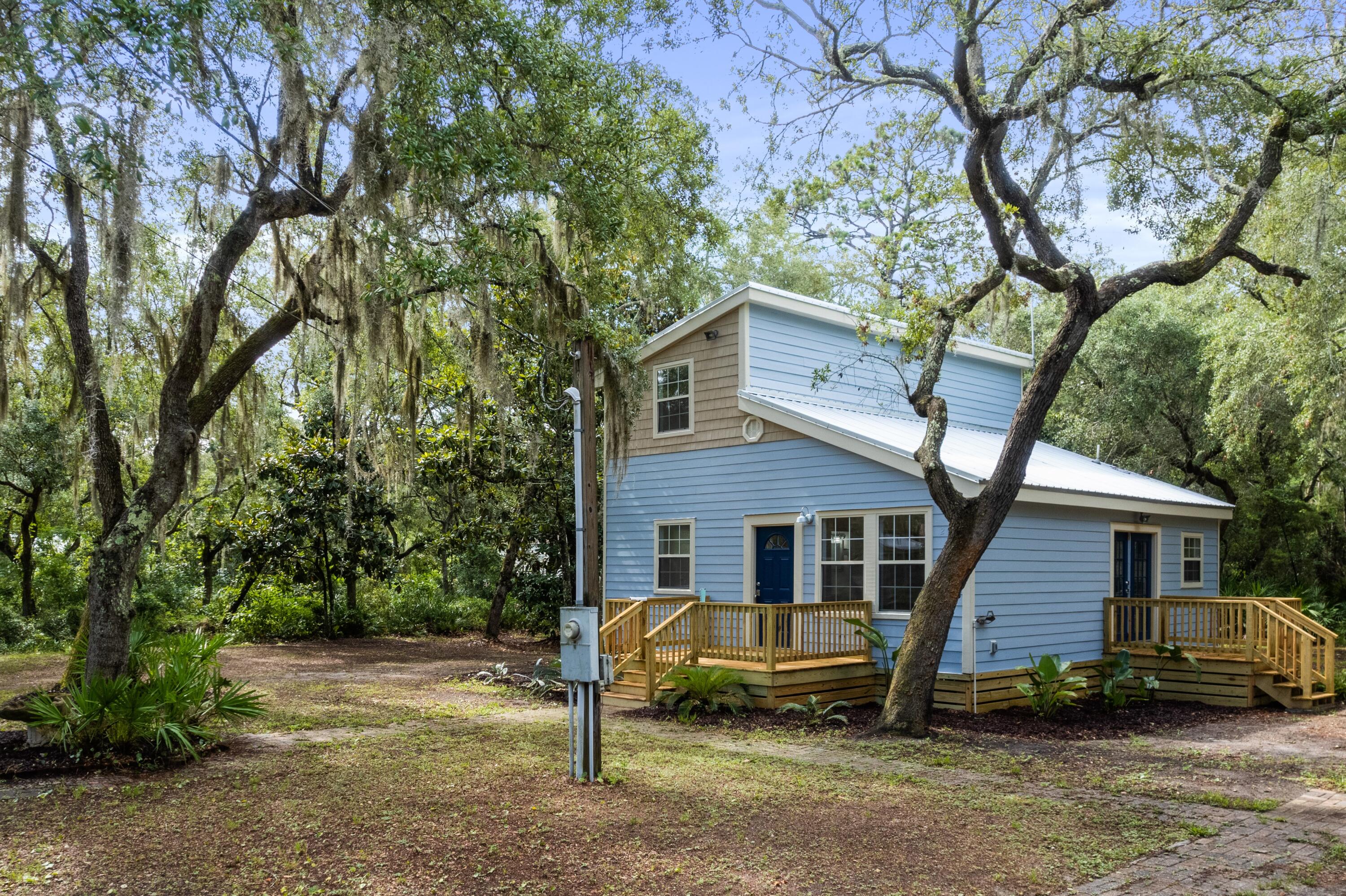 200 East Harborview Road Santa Rosa Beach, FL 32459 - Photo 3 of 20 a front view of a house with a garden