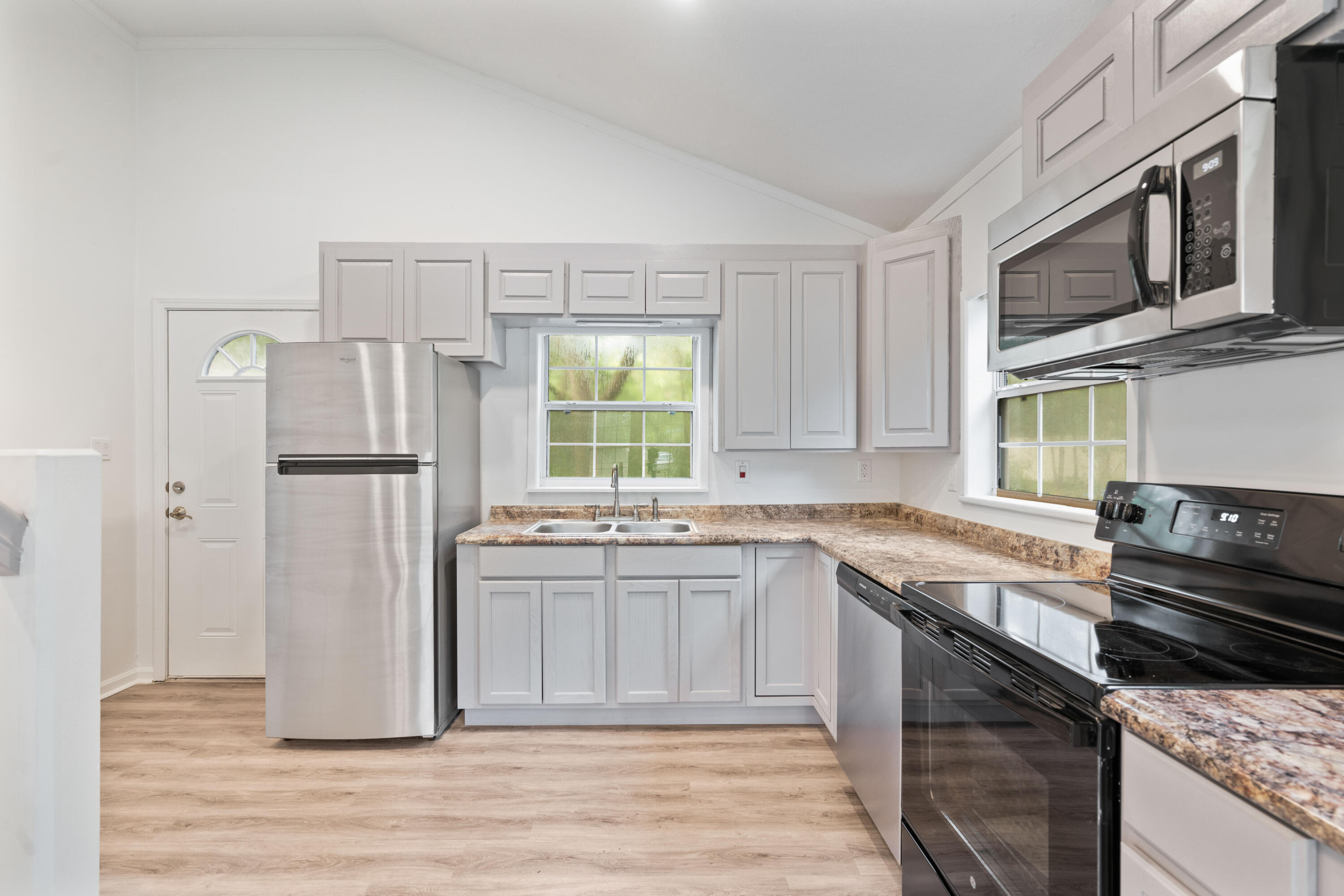200 East Harborview Road Santa Rosa Beach, FL 32459 - Photo 4 of 20 a kitchen with stainless steel appliances granite countertop a refrigerator and a stove top oven
