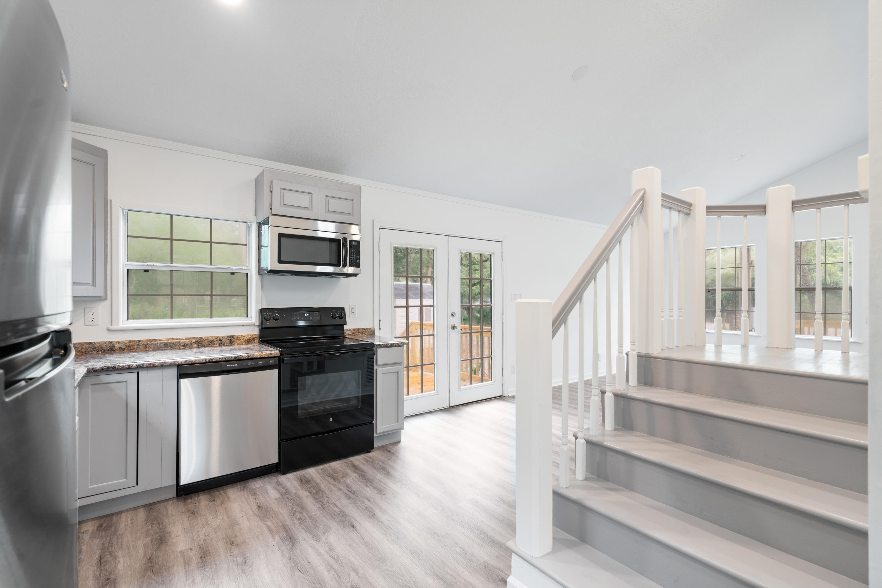 200 East Harborview Road Santa Rosa Beach, FL 32459 - Photo 5 of 20 a kitchen with granite countertop a stove top oven a sink and a granite counter top