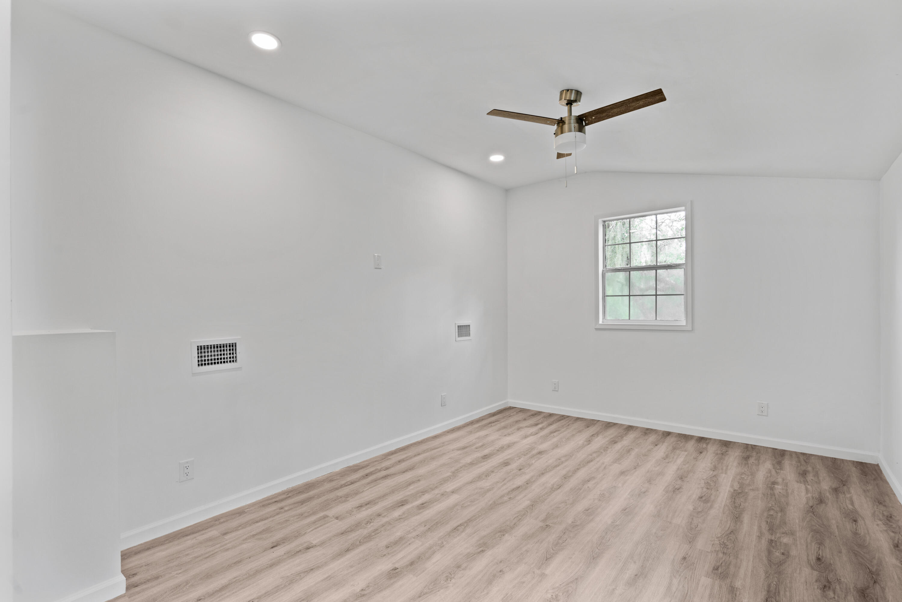 200 East Harborview Road Santa Rosa Beach, FL 32459 - Photo 9 of 20 wooden floor in an empty room with a window