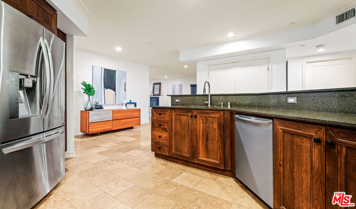 1420 South Bundy Drive, Unit 101 Los Angeles, CA 90025 - Photo 11 of 37 a kitchen with granite countertop a refrigerator and a sink