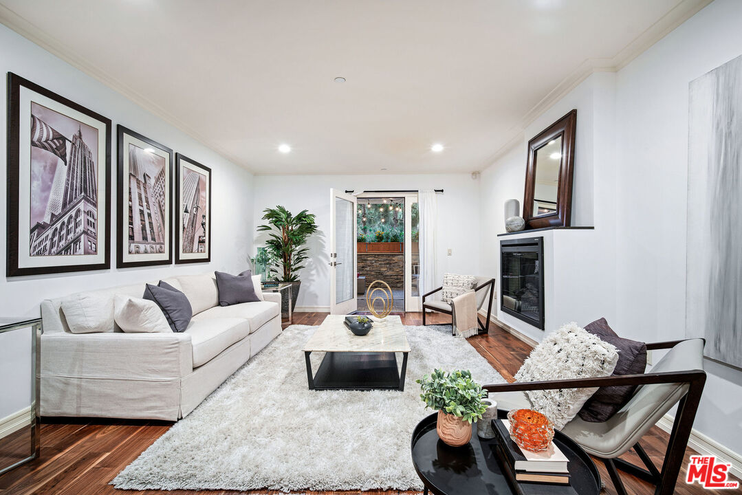 1420 South Bundy Drive, Unit 101 Los Angeles, CA 90025 - Photo 13 of 37 a living room with furniture and wooden floor